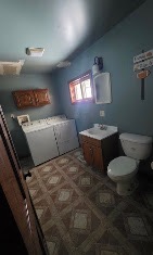 Bathroom and laundry room refreshed with blue walls and a new vanity by T & A Contracting