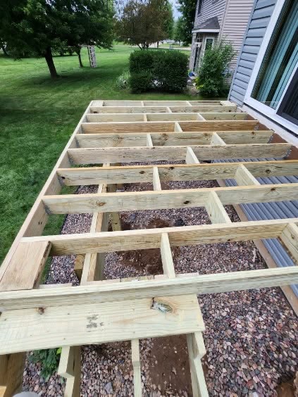Level deck joist framing over gravel for a new deck by T & A Contracting