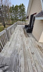 Long weathered gray deck alongside a home before restoration by T & A Contracting
