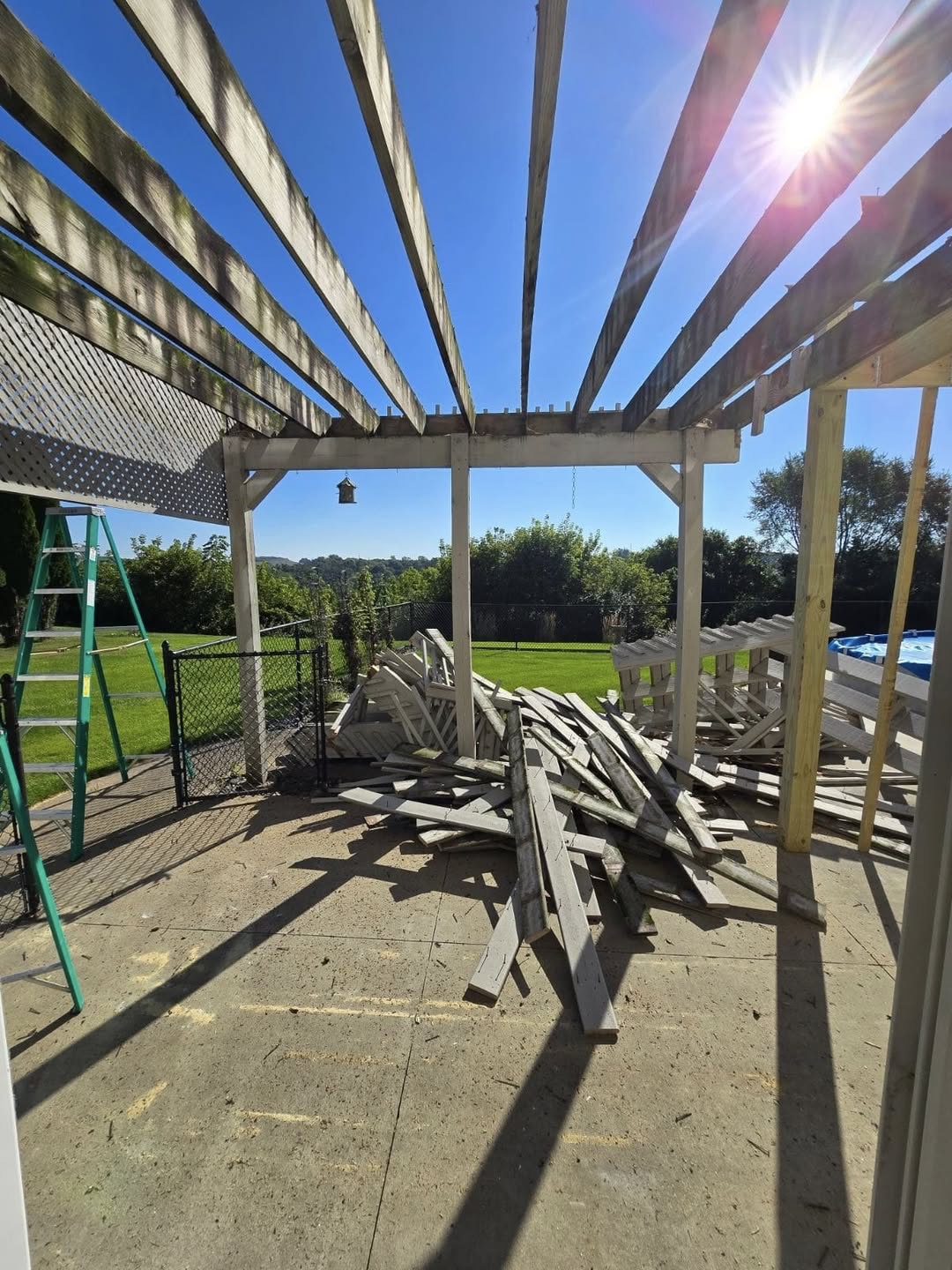 Aging poolside pergola being demolished and cleared for a rebuild by T & A Contracting