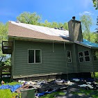 Lakeside cabin getting a full green exterior stain refresh by T & A Contracting