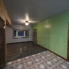 Interior room repainted with a green accent wall by T & A Contracting