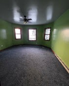 Bedroom repainted with soft green walls and white trim by T & A Contracting