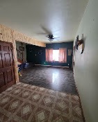 Open living space repainted with a dark accent wall by T & A Contracting