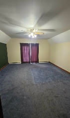 Spacious room repainted with a two-tone accent wall and stained trim by T & A Contracting