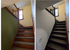 Interior staircase with refinished wood treads and a black railing remodeled by T & A Contracting