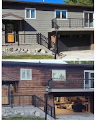 Home exterior updated with warm wood-tone siding and a deck by T & A Contracting