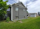 Two-story home with gray lap siding and white trim by T & A Contracting